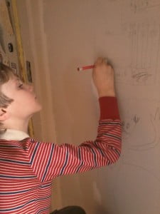 kid draws on wall